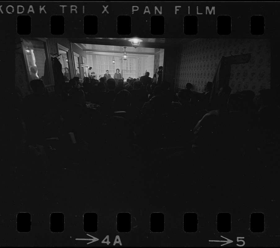 Dim view of Louise Day Hicks speaking to an audience at a restaurant, most likely campaigning for mayor or city council