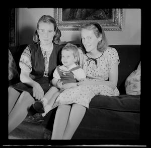 Two women with young girl on sofa