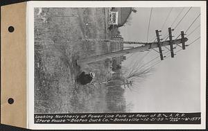 Looking northerly at power line pole at rear of Boston and Albany Railroad storehouse, Boston Duck Co., Bondsville, Palmer, Mass., Dec. 21, 1939