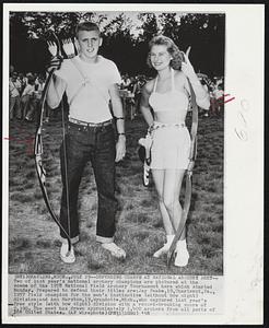 Grayling, Mich. -- Defending Champs At National Archery Meet -- Two of last year’s national archery champions are pictured at the scene of the 1958 National Field Archery Tournament here which started Monday. Prepared to defend their titles are: Jake Peake, 19, Charleroi, Pa., 1957 field champion for the men’s instinctive (without bow sight) division; and Ann Marston, 19, Wyandotte, Mich., who captured last year’s free style (with bow sight) division with a record-breaking score of 2390. The meet has drawn approximately 1400 archers from all parts of the United States.