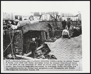 Flood Disaster Scene--Auto in which Thomas R. Moody, his wife and three children tried to escape from flood rests on its back on top wreckage of shed on which they sought refuge during night. Mrs. Moody's body was recovered in wreckage today. Children are in hospital, saved by father and neighbor.