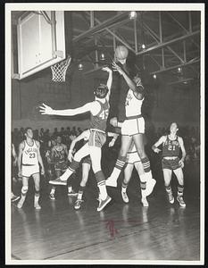 Flying High - Artie Johnson (24) of Boston English shoots over defender in 68-58 victory over BC High that clinched at least tie for City League title.