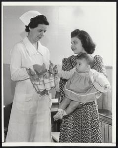 Infant Feeding Service Organized. Chicago- Little Annette Casiello sees some thing familiar during a visit to the new Infant Feeding Service with her mother to have her formula made up.