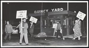 Strikers at the Quincy Shipyard of Bethlehem Steel Co. began forming within minutes after the midnight walkout call. Picket at far right wears blanket to keep warm in the freezing pre-dawn temperature.