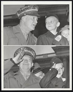 “Salute When I Salute.” Noticing that seven-year-old Maurice J. Tobin, Jr., son of the governor of Massachusetts, was uncertain about when to salute Armistice Day Parade units passing in front of the reviewing stand in Boston today (Nov. 12) Gen. Dwight D. Eisenhower (top photo) says: “Salute When I Salute.” Lower photo: They salute in unison.