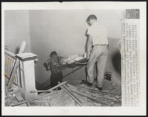 Quake Victim Removed--An injured woman is removed from the badly shaken Continental Hotel after today's strong quake in Bakersfield. Debris litters the floor.