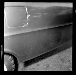 Close up of the side of a car, with gas tank door visible