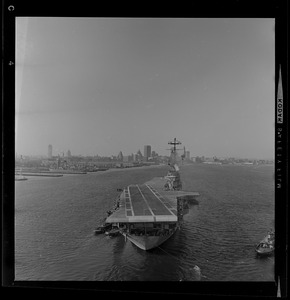 Head-on view of USS Wasp carrier with a landing strip nearing the Boston coastline