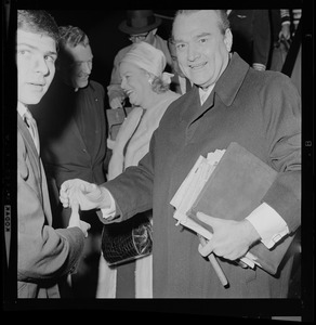 Red Skelton goes to shake hands with another young man