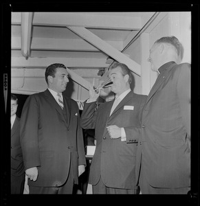 Red Skelton drinking from a cup as two others look on