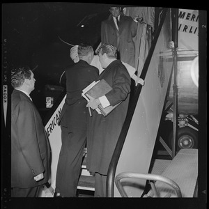 Woman, most likely Georgia Davis, behind her husband, Red Skelton, while exiting from an American Airlines flight
