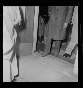 Men walking into a room, shot from the waist down