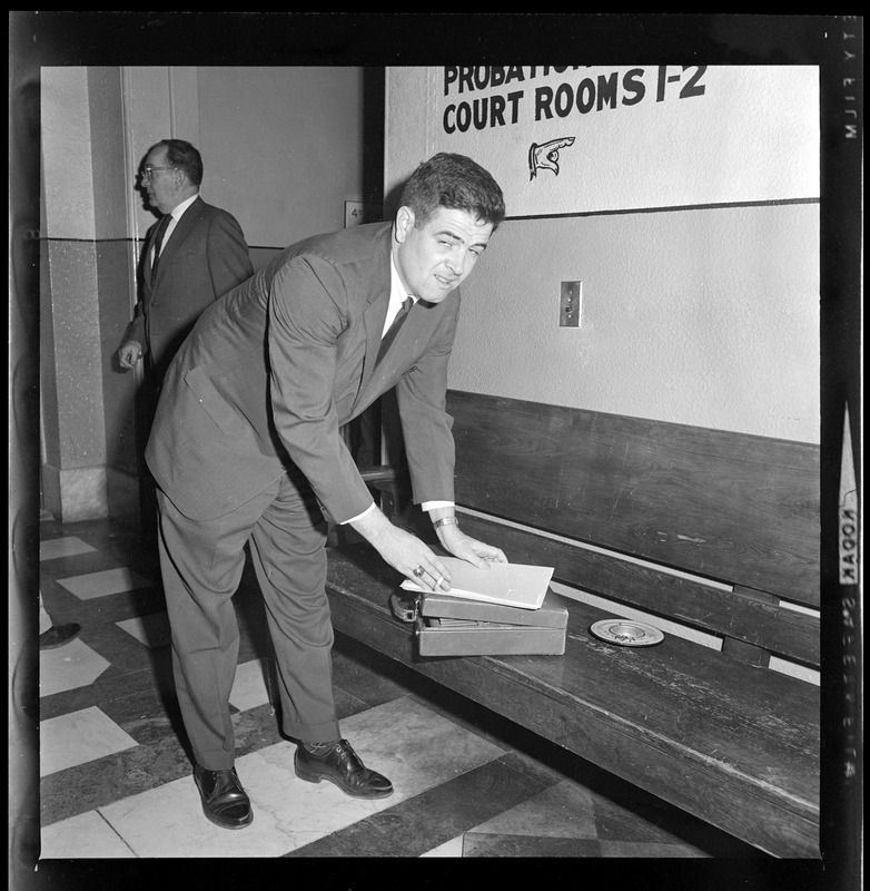 Assistant District Attorney Donald Conn with documents outside of the court room