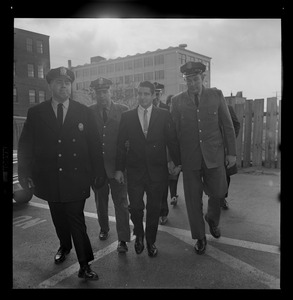 Albert DeSalvo walking with officers outside