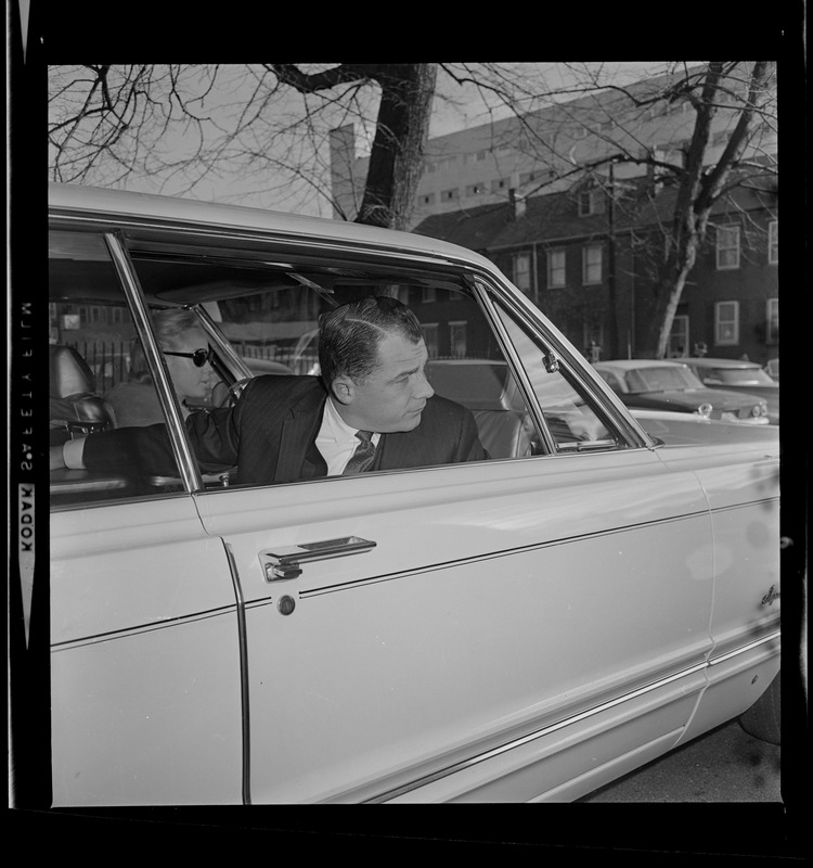 F. Lee Bailey, criminal defense attorney, in a car and looking over his shoulder
