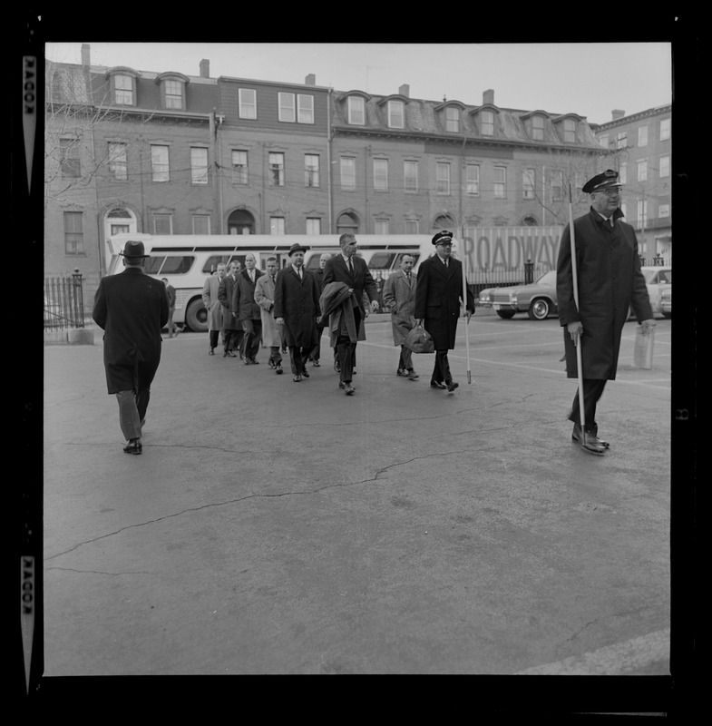 Jury walking off the bus, lead by bailiffs