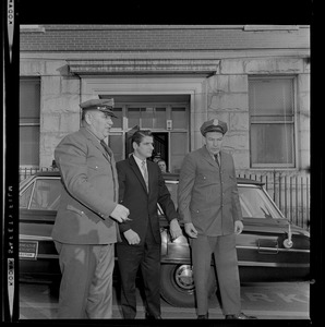 Albert DeSalvo with guards, including guard Brauni Norkus, left, walking from the car towards the courthouse