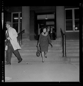 Woman exiting courthouse and walking down the stairs