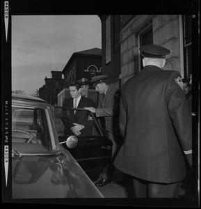 Guards leading Albert DeSalvo into the vehicle