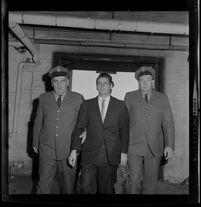Brauni Norkus, left, Albert DeSalvo, middle, and another guard walking into the building