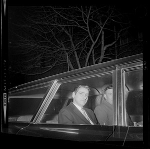 Albert DeSalvo in back seat of vehicle with a guard