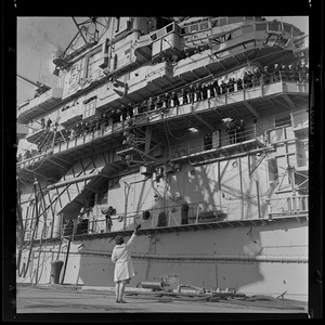 View of a woman waving to the crew aboard the USS Wasp carrier