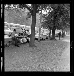 Police motorcycles, cars, and buses along campus