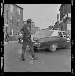 Officer standing behind a vehicle