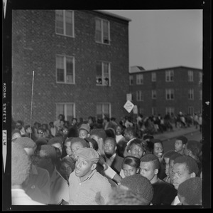 Large gathering in street with young students