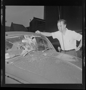 James Devereaux with his smashed windshield at the corner of Harrison Ave. and Dudley St.