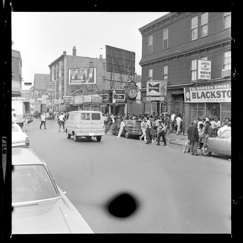 Crowd on sidewalk outside of New Clock Cafe