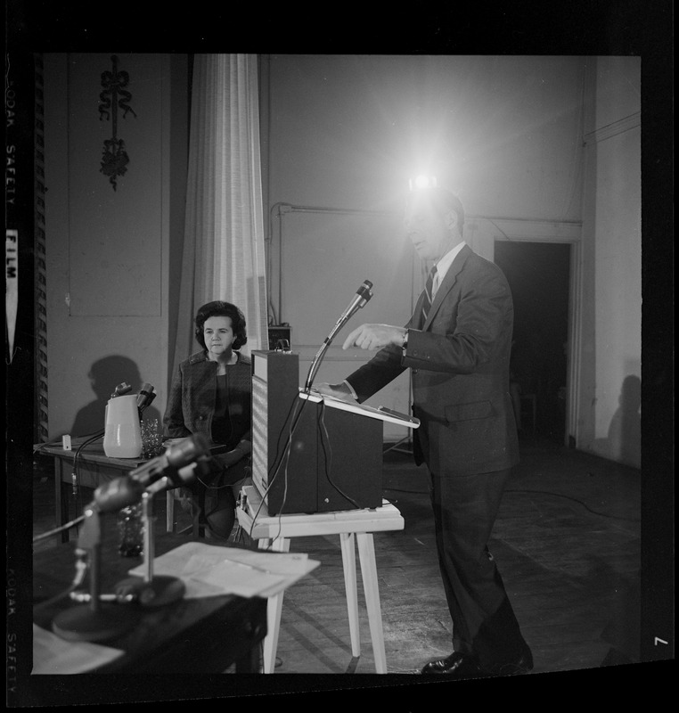 Kevin White addressing the room during the debate as Louise Day Hicks looks on