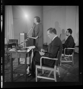 Louise Day Hicks addresses the room during the debate as Kevin White takes notes