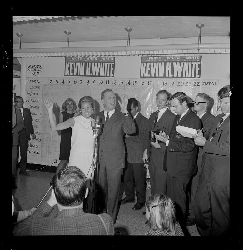 Sec. of State and Mrs. Kevin White wave happily to campaign workers at his headquarters last night