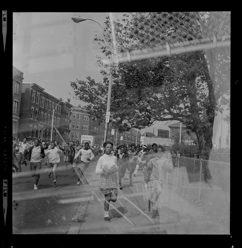 Students running down a street