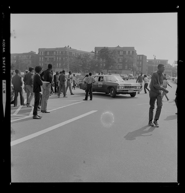 Boston Police car making its way through the crowds on streets