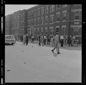 Group of police canvassing the street