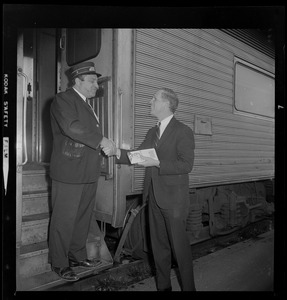 Kevin White shaking hands with a train operator or engineer