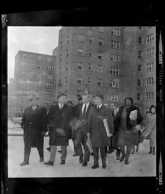 Mayor Kevin White walking with others at the Columbia Point Housing Project