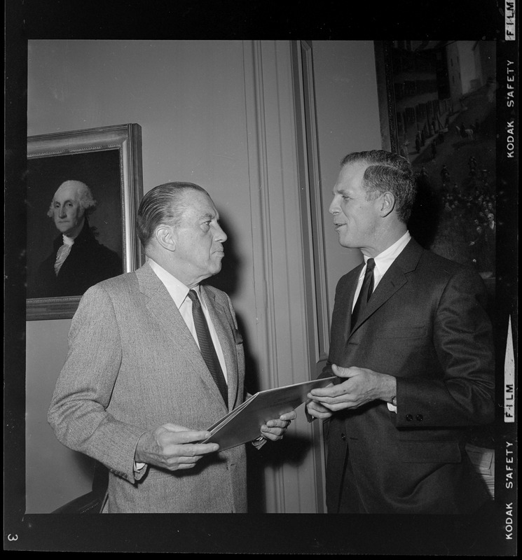 Mayor Kevin White handing Ed Sullivan a folio