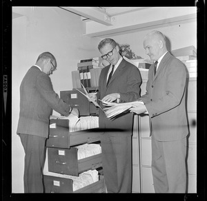 Secretary of State Kevin H. White, center, with Norman Gleason, left, supervisor of elections in White's office, and James Kane, supervisor of financial records of political candidates