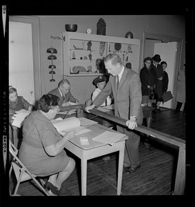 Sec. of State Kevin White checks in at his local polling place to cast his vote