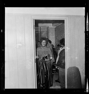 A woman seen standing in doorway of a room at the Maurice Tobin Memorial Building