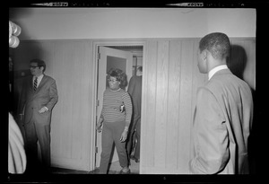 A woman exits a meeting room in the Maurice Tobin Memorial Building