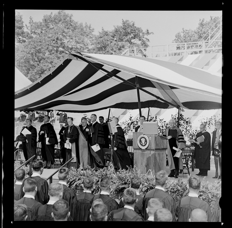 President Johnson and other honorary degree recipients on stage at commencement ceremony at Holy Cross College