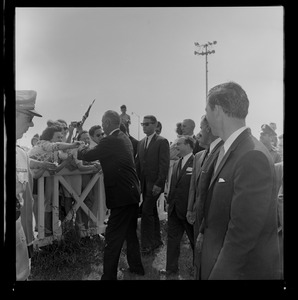 President Johnson stops to shake hands with fans