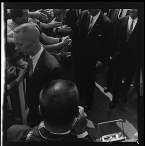 President Johnson, in partial view, moving through crowds