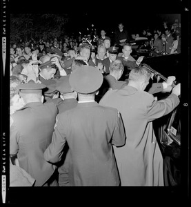 President Johnson making his way through the crowd and into car