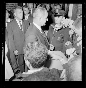 President Johnson talks with reporters, most likely outside of N.E. Baptist Hospital