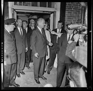 President Johnson talks with a reporter while walking out of N.E. Baptist Hospital